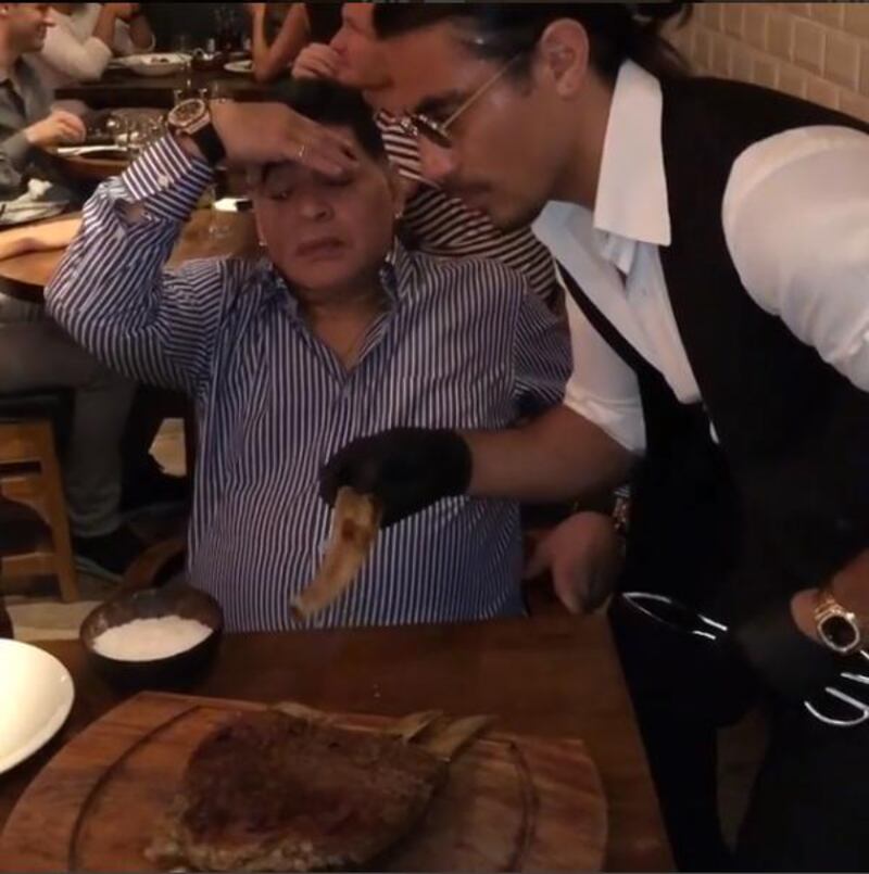 Nusret Gökçe serves Maradona some ribs. Courtesy Nusret Gökçe Instagram