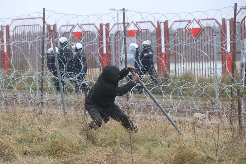 A man breaks a fence at the border. Reuters