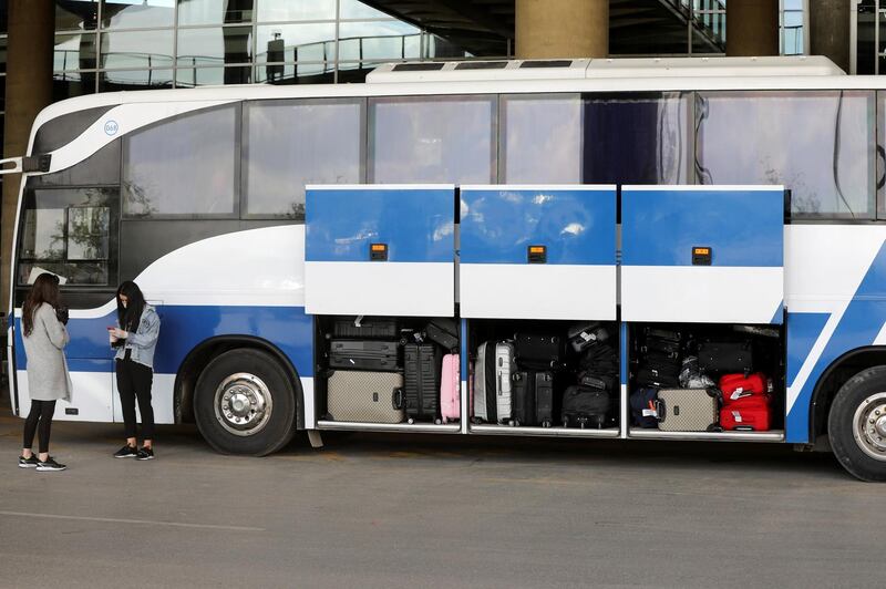 Jordanian students who were studying abroad wait on a bus that will take them to a quarantine area at Queen Alia International Airport in Amman, Jordan. Reuters