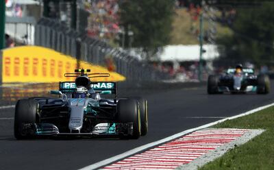 Mercedes' Finnish driver Valtteri Bottas (Front) and Mercedes' British driver Lewis Hamilton (Back) race at the Hungaroring circuit in Budapest on July 30, 2017, during the Formula One Hungarian Grand Prix. / AFP PHOTO / Peter Kohalmi