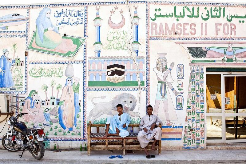 Employees sit and wait for customers outside their tourist store in Luxor, Egypt. Egypt’s government is crowding out private economic activity. Shawn Baldwin / Bloomberg