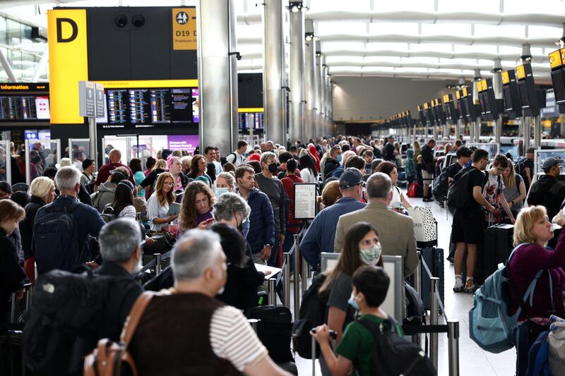 Passengers queue inside the departures terminal of Terminal 2 at Heathrow Airport. Reuters