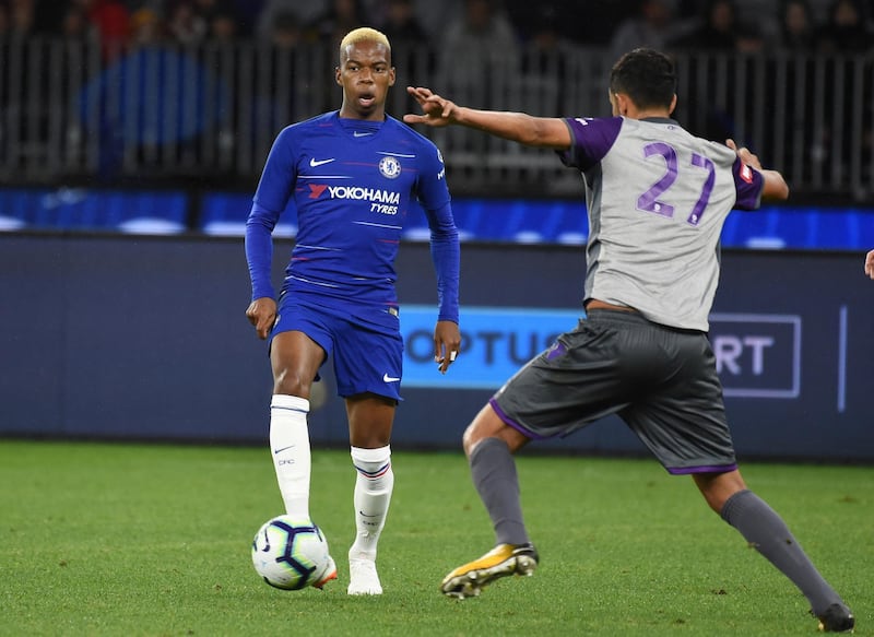 Chelsea's Charly Musonda (L) passes the ball away from Juan Prados Lopez from Perth Glory during the football friendly match at Optus Stadium in Perth on July 23, 2018. 