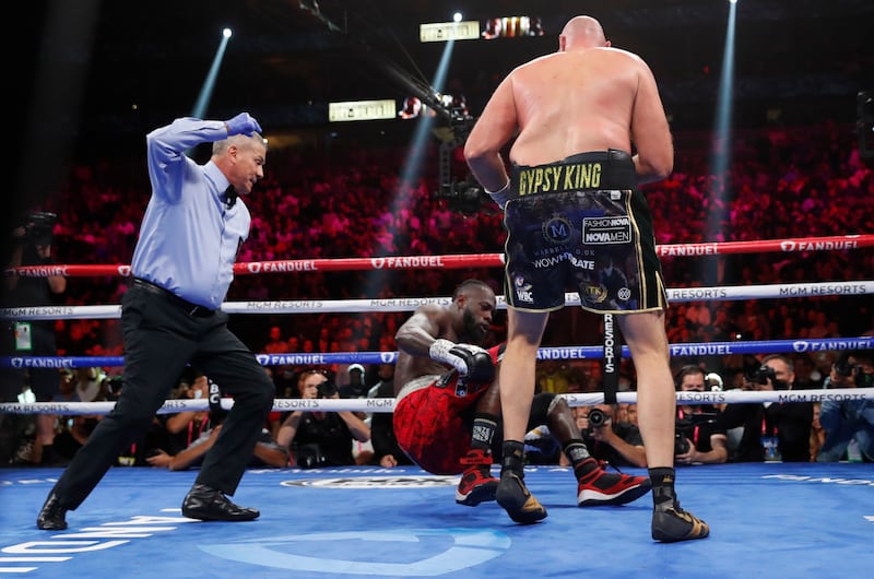 Tyson Fury knocks down Deontay Wilder. Reuters