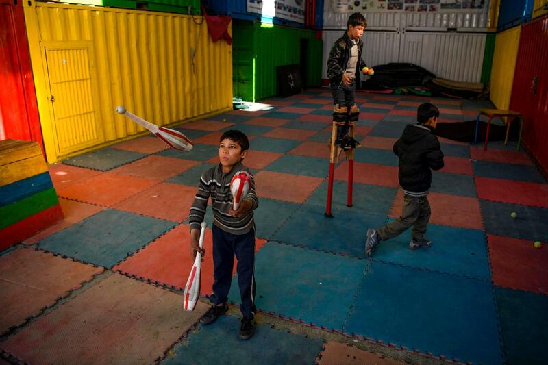 Children learn how to juggle with balls and clubs at the Mobile Mini Circus for Children (MMCC), an Afghanistan's travelling educational entertainment group teaching children aged 5 to 17, in Kabul. AFP