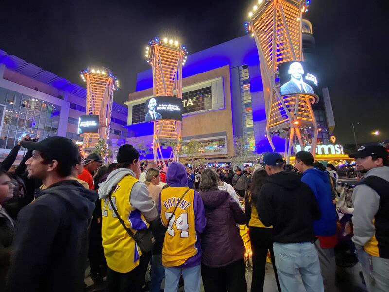 People gather around a makeshift memorial for late basketball legend Kobe Bryant at the Staples centre in Los Angeles on January 26, 2020, a few hours after the announcement of his death. AFP