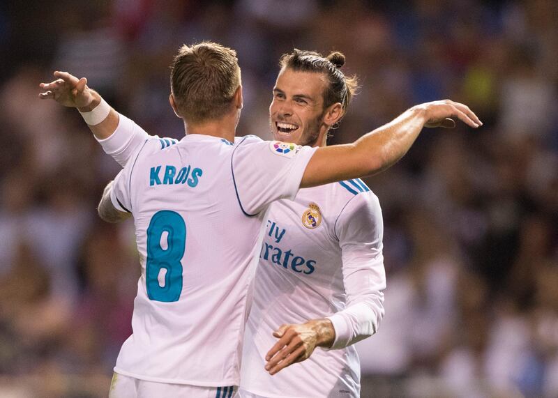 Real Madrid's Toni Kroos, left, is congratulated by Real Madrid's Gareth Bale after scoring a goal during a Spanish La Liga soccer match between Deportivo and Real Madrid at the Riazor stadium in A Coruna, Spain, Sunday, Aug. 20, 2017. (AP Photo/Lalo R. Villar)