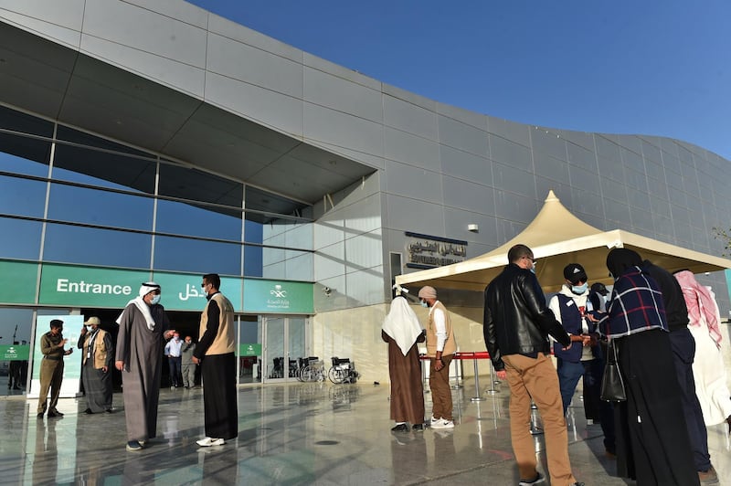 People gather outside the Riyadh International Convention and Exhibition Centre before receiving a dose of the Covid-19 vaccine in Riyadh.  AFP