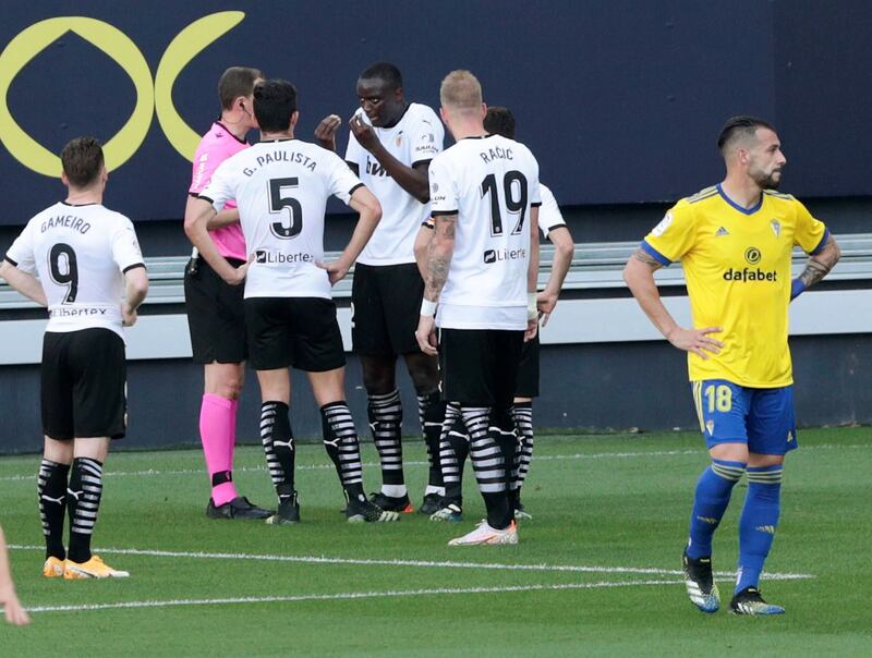 Valencia's French defender Mouctar Diakhaby talks with referee David Medie Jimenez after allegedly receiving a racist comment by Cadiz defender Juan Cala. EPA