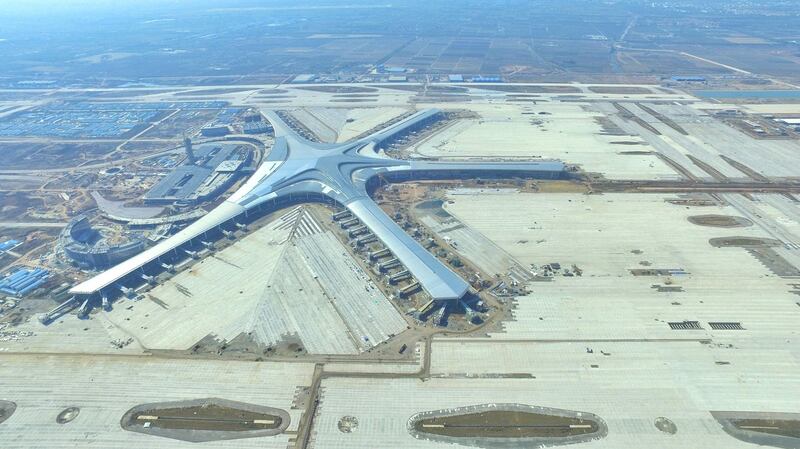 An aerial view of the Qingdao Jiaodong International Airport under construction in Jiaozhou on the outskirts of Qingdao city, east China's Shandong province, 19 October 2018.

Qingdao Jiaodong International Airport will help Qingdao to become an international metropolis and reshape the aviation network in Northeast Asia, according to the city government. The new airport, which is currently under construction, is located in Jiaozhou on the outskirts of Qingdao, approximately 39 kilometers from the city's downtown area. It has attracted a total investment of more than 44.3 billion yuan ($6.45 billion). The first phase of construction is due to be completed by 2025 and will feature a 478,000-square-meter terminal and 178 landing slots. It is expected to handle 35 million passengers, 500,000 metric tons of cargo and nearly 300,000 aircraft annually.No Use China. No Use France.