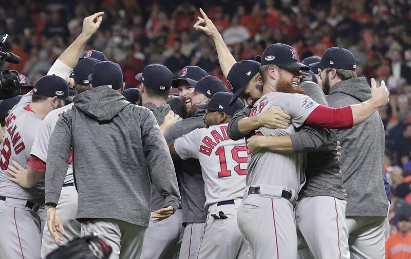 epa07103459 Boston Red Sox players celebrate after defeating the Houston Astros in game five of the American League Championship Series at Minute Maid Park in Houston, Texas, USA, 18 October 2018. The Red Sox win the ALCS four games to one will go on to face either the Milwaukee Brewers or the Los Angeles Dodgers in the World Series.  EPA/MICHAEL WYKE