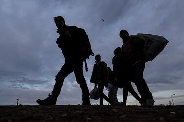 A group of migrants and refugees walk to Pazarkule Border gate during the sunset at the city centre of Edirne, Turkey. EPA