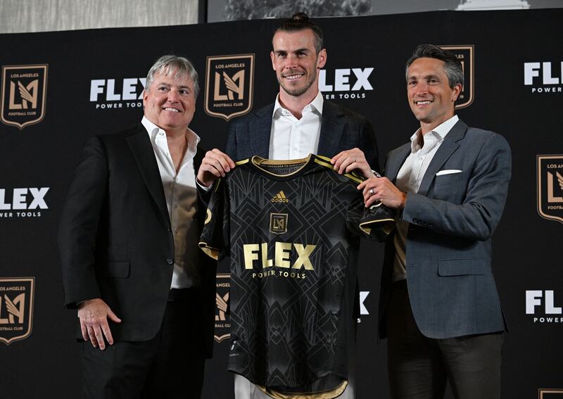 Gareth Bale poses for photos with LAFC lead managing owner Larry Berg, left, and LAFC Co-President and General Manager John Thorringto. AFP