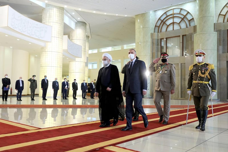 Iraqi Prime Minister Mustafa Al Kadhimi is welcomed by Iranian President Hassan Rouhani. AP