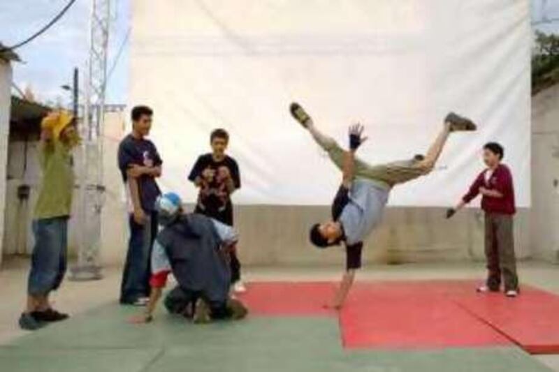 Yemen - Sana'a - Aug 12 - 2008 : George Masriya, 15,  perform breakdance while their friends watch him at the French Cultural Center. ( Jaime Puebla / The National ) *** Local Caption ***  JP112- YEMEN BREAKDANCE.jpg