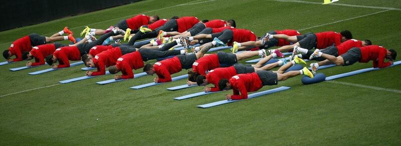 Atletico Madrid players stretch during Monday's training session as they prepare to go up against Real Madrid in the Champions League final on Saturday. Sergio Perez / Reuters / May 19, 2014