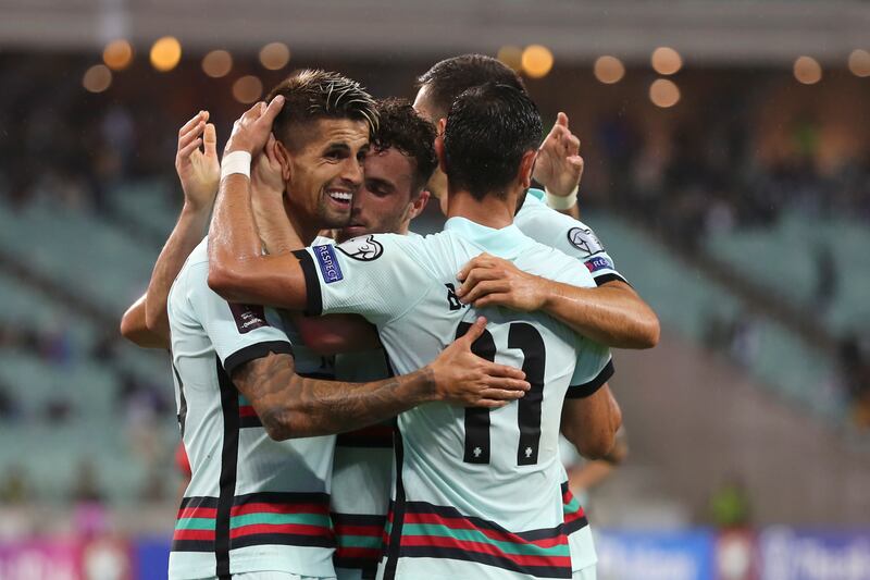 Portugal players celebrate after Diogo Jota scored his side's third goal. AP