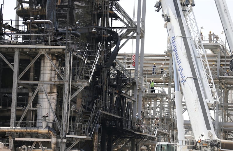 Workers are seen at the damaged site of Saudi Aramco oil facility in Khurais. Reuters