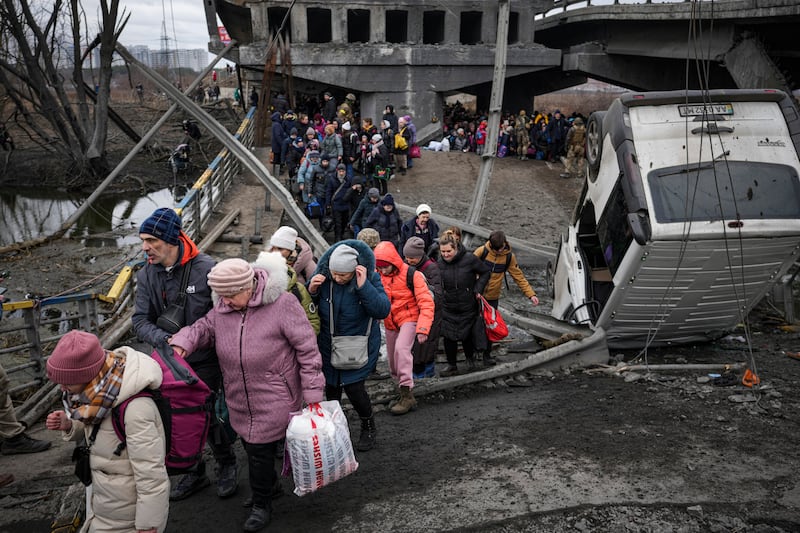 Residents flee the town of Irpin, near Kyiv, Ukraine. AP Photo