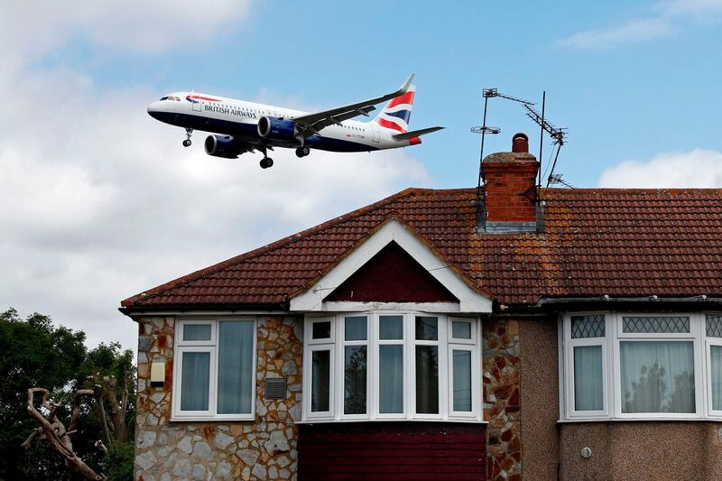 (FILES) In this file photo taken on June 08, 2020 A British Airways Airbus A320 comes in over houses, to land at Heathrow airport in west London. Passengers flying from Heathrow to Hong Kong on October 20, 2020 will be the first to have the option of paying for a rapid Covid test before checking in. / AFP / Adrian DENNIS
