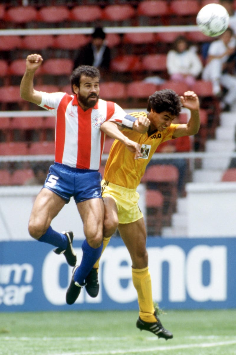 Paraguay's Rogelio Delgado (l) heads clear from Iraq's Ahmed Radhi (r)  (Photo by Peter Robinson/EMPICS via Getty Images)