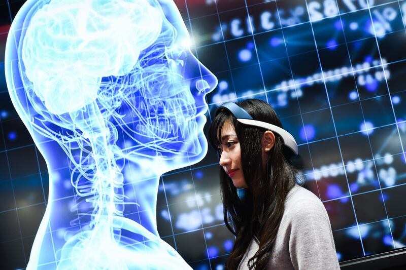 An attendant wears a Tokai Optical Co. 'Nurotailormade' at the company's booth at the Combined Exhibition of Advanced Technologies (CEATEC) Japan in Chiba, Japan, on Monday, Oct. 15, 2018. CEATEC, an information technology and electronics trade show, will run until Oct. 19. Photographer: Noriko Hayashi/Bloomberg