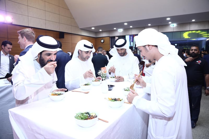 epa06759718 UAE officials and journalists eat 'Bibimbap', a traditional Korean dish of mixed rice and vegetables, during an Iftar (breakfast) at the Korean embassy in Abu Dhabi, United Arab Emirates, 23 May 23 2018. Iftar is the first evening meal at the end of fasting during Ramadan.  EPA/YONHAP SOUTH KOREA OUT