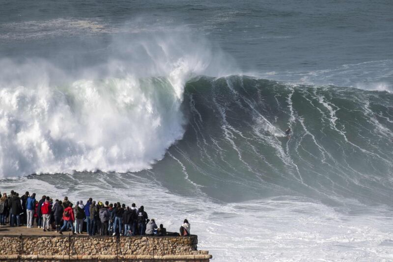 British surfer Tom Butler rides a wave during a free surfing session in Nazare. AFP