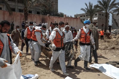 People and health workers unearth bodies found at Nasser Hospital in Khan Younis. AFP