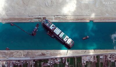 This satellite image from Maxar Technologies shows the cargo ship MV Ever Given stuck in the Suez Canal near Suez, Egypt, Sunday, March 28, 2021. Two additional tugboats sped Sunday to Egypt's Suez Canal to aid efforts to free the skyscraper-sized container ship wedged for days across the crucial waterway, even as major shippers increasingly divert their boats out of fear the vessel may take even longer to free. (Â©Maxar Technologies via AP)