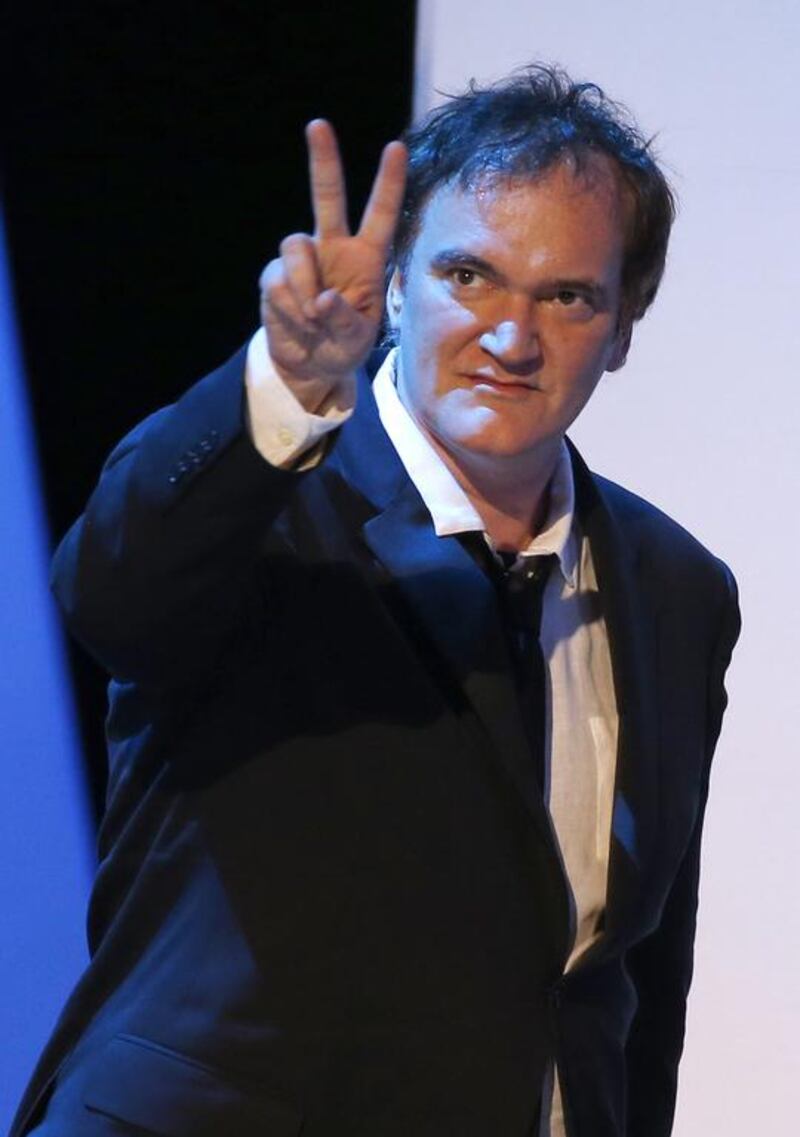 US director Quentin Tarantino flashes the victory sign as he walks on stage. Etienne Laurent / EPA