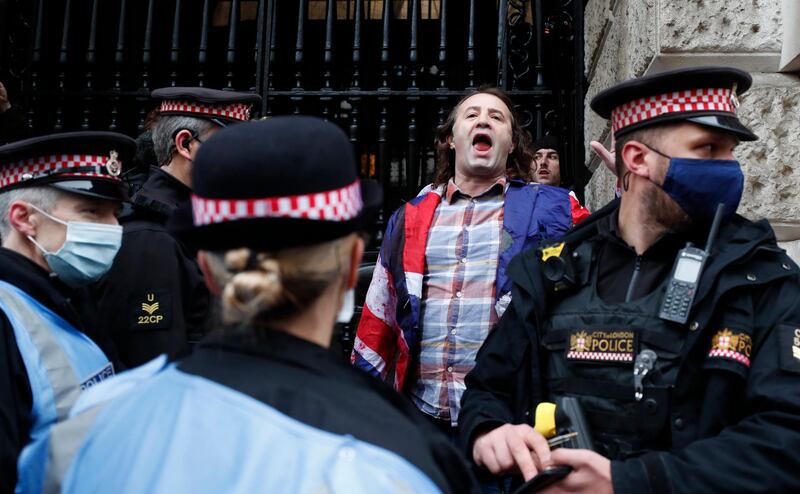 A Julian Assange supporter shouting out his support is surrounded by police outside the Old Bailey in London. AP Photo
