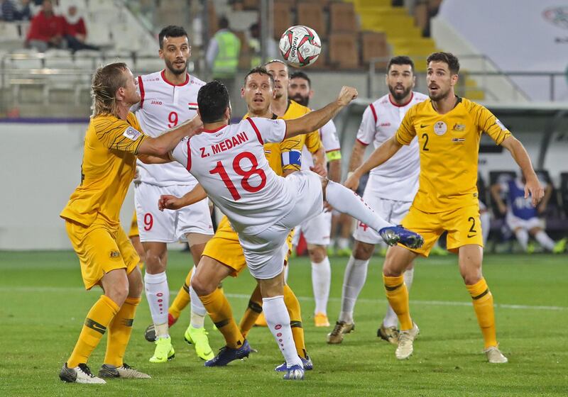 Syria's midfielder Zaher Midani jumps for the ball. AFP