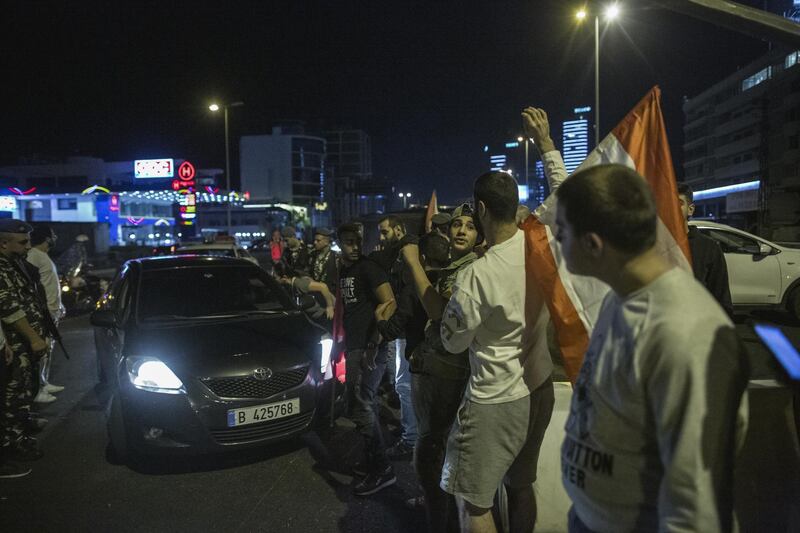 Anti-government protesters wave through cars during an hour-long amnesty in which they opened one lane to traffic on the highway entering Beirut in Jal El Dib, Lebanon. Getty Images