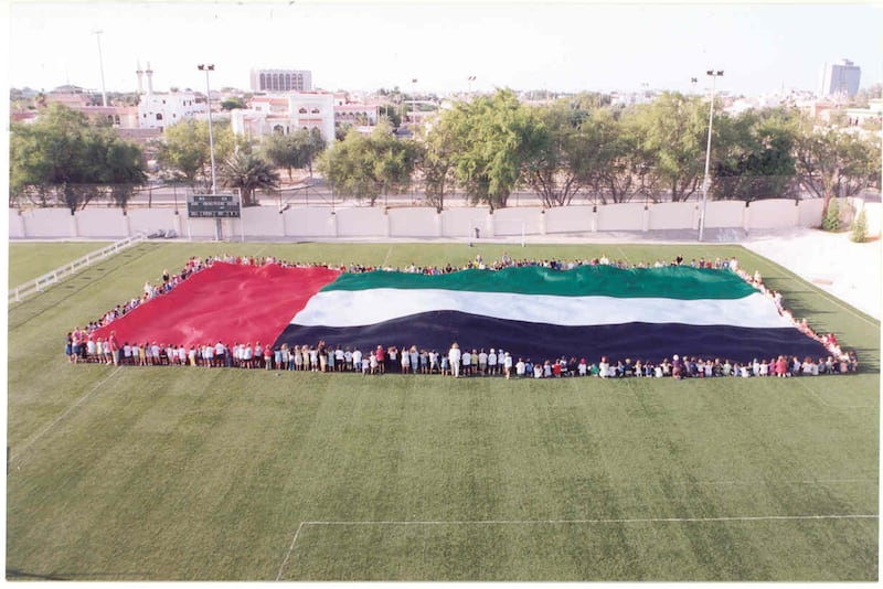 Pupils at The American Community School, Abu Dhabi, holding the first giant UAE flag before Trident Support raised it on the world record 123-metre flagpole on the Corniche Breakwater in 2001.