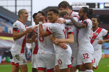 Southampton's James Ward-Prowse is mobbed by teammates as hecelebrates after scoring his sides third goal of the game during the English Premier League soccer match between Aston Villa and Southampton at Villa Park in Birmingham, England, Sunday, Nov. 1, 2020. (Gareth Copley/Pool via AP)