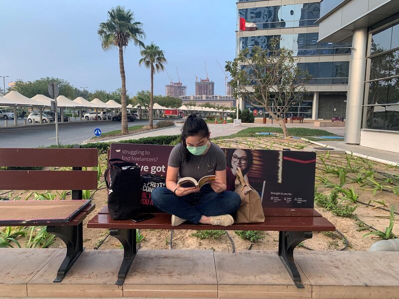 A girl wearing a face mask reads a book, following the outbreak of coronavirus disease (COVID-19), in Dubai, United Arab Emirates March 26, 2020. REUTERS/Ahmed Jadallah