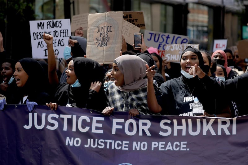 People take part in a justice for Shukri Abdi protest on the first anniversary of her death near Parliament Square in London, Saturday, June 27, 2020. The 12-year-old schoolgirl of Somali heritage, who was born in a refugee camp in Kenya, drowned in the River Irwell in Bury, Greater Manchester on June 27, 2019. Greater Manchester Police said it was treating what happened as a "tragic incident" and did not believe there were any suspicious circumstances, campaigners and the mayor of Greater Manchester are pressing for a full investigation, an inquest was adjourned in February. (AP Photo/Matt Dunham)