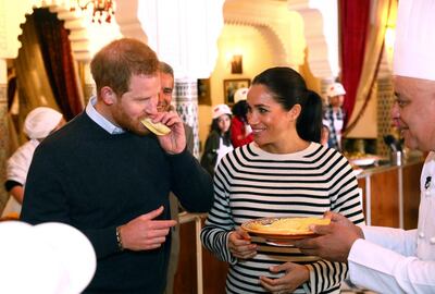 Britain's Prince Harry and Meghan, Duchess of Sussex, try food as they visit a cooking school demonstration at the Villa des Ambassadors in Rabat, Morocco, Monday Feb. 25, 2019.  The royal couple sampled food, where children from under-privileged backgrounds learn traditional Moroccan recipes from one of Moroccos foremost chefs. (Tim P. Whitby/Pool via AP)