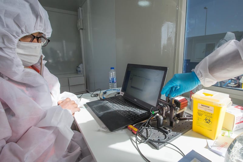 Dubai, United Arab Emirates -Medical staff processing  blood sample at the new DPI Testing Centres border of Dubai and Abu Dhabi.  Leslie Pableo for The National for Shireena Al Nowais story