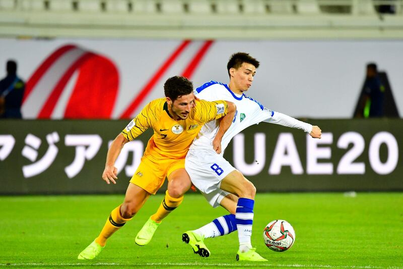 Australia forward Mathew Leckie, left, vies for the ball with Uzbekistan midfielder Ikram Alibaev. AFP