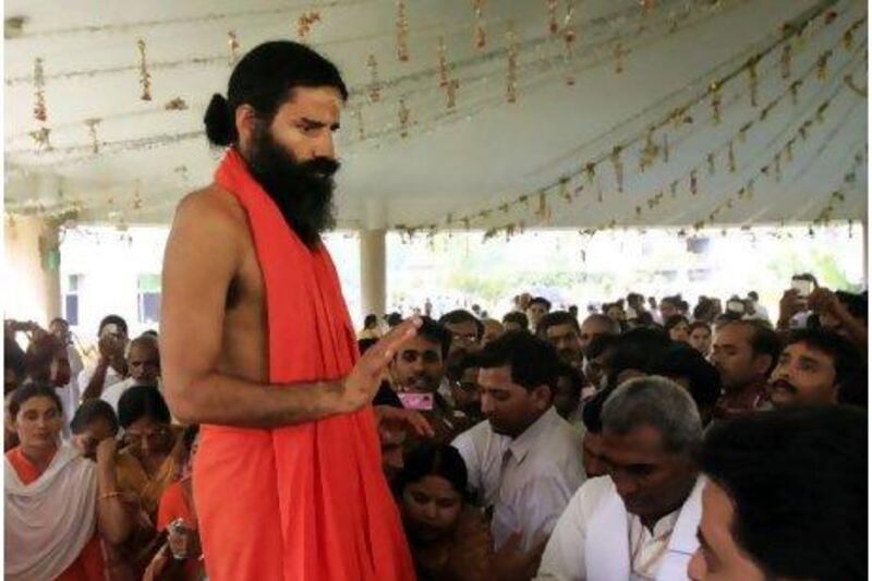 Yoga guru Baba Ramdev tells followers at his ashram in Haridwar yesterday that he would continue a hunger strike in protest at corruption in India.