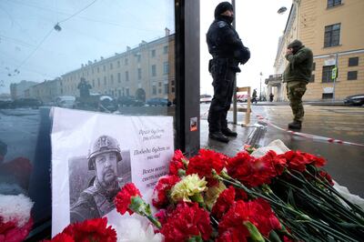 A photo of blogger Vladlen Tatarsky placed near the site of an explosion at a cafe in St Petersburg, Russia. AP