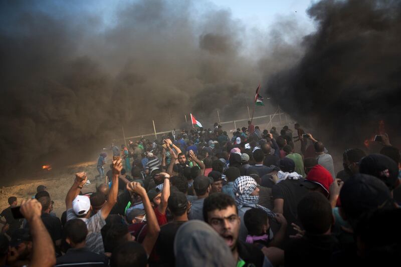 Palestinian protesters protest at the Gaza Strip's border with Israel, Friday, Sept.28, 2018. (AP Photo/Khalil Hamra)