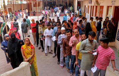 People wait in queues to cast their votes at a polling station during the Madhya Pradesh state assembly election in Indore. Reuters