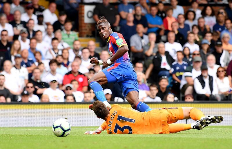 LONDON, ENGLAND - AUGUST 11:  Wilfried Zaha of Crystal Palace scores his team's second goal past Fabricio Agosto Ramirez of Fulham during the Premier League match between Fulham FC and Crystal Palace at Craven Cottage on August 11, 2018 in London, United Kingdom.  (Photo by Justin Setterfield/Getty Images)