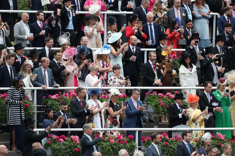 Crowds cheer and clap as Queen Elizabeth II arrives on day five of Royal Ascot at Ascot Racecourse. PA Images