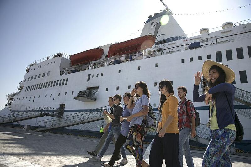 Volunteers for the Logos Hope head ashore to welcome visitors yesterday after the ship docked at Mina Zayed in Abu Dhabi. Silvia Razgova / The National



