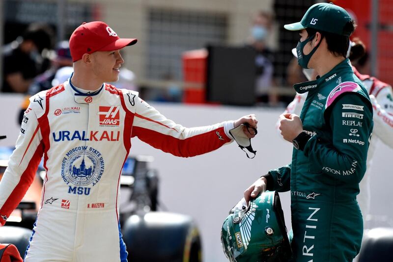 Haas F1's German driver Mick Schumacher greets Aston Martin's Canadian driver Lance Stroll during the first day of the Formula One pre-season testing at the Bahrain International Circuit in the city of Sakhir on March 12, 2021. AFP