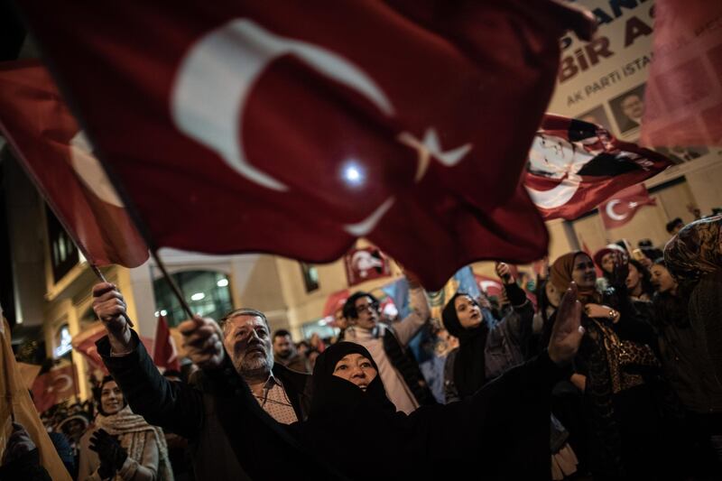 Supporters of Justice and Development Party (AK Party) wave Turkish flags as they celebrate early results for Istanbul mayor in local elections in Istanbul.  EPA